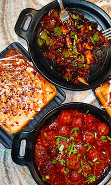 Rich butter paneer curry in a cast iron pan